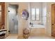 Luxurious bathroom with a standalone tub, glass-enclosed shower, and stylish fixtures, creating a spa-like retreat at 7846 E Wilderness Trl, Gold Canyon, AZ 85118