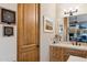 Bathroom with framed artwork and a wooden vanity featuring an undermount sink and modern faucet at 7846 E Wilderness Trl, Gold Canyon, AZ 85118