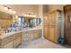 Well-lit bathroom features dual sinks, wooden cabinetry, and ample counter space at 7846 E Wilderness Trl, Gold Canyon, AZ 85118