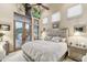 Bright bedroom with large windows, balcony access, neutral color palette, and mirrored bedside tables at 7846 E Wilderness Trl, Gold Canyon, AZ 85118
