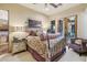 A luxurious bedroom featuring an ornate iron bed frame, stylish lamps, and access to an outdoor patio at 7846 E Wilderness Trl, Gold Canyon, AZ 85118
