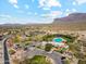 Aerial of community pool and neighborhood with mountains in the distance at 7846 E Wilderness Trl, Gold Canyon, AZ 85118