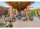 Relaxing courtyard featuring a beautiful seating area, desert landscaping, hanging decor, and stunning desert sunsets at 7846 E Wilderness Trl, Gold Canyon, AZ 85118