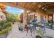 Enchanting covered courtyard with charming decor, potted plants, flowering gardens and an outdoor seating area at 7846 E Wilderness Trl, Gold Canyon, AZ 85118