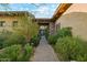Charming entryway, desert landscaping and tile walkway leading to the home entrance with beautiful courtyard views at 7846 E Wilderness Trl, Gold Canyon, AZ 85118