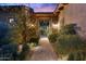 Inviting front entrance with stone accents, landscaped walkway, and decorative gate at 7846 E Wilderness Trl, Gold Canyon, AZ 85118