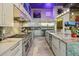Open kitchen with stainless steel appliances, marble countertops, and neon art at 7846 E Wilderness Trl, Gold Canyon, AZ 85118