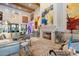 Grand living room with soaring ceilings, fireplace, art and comfortable leather seating at 7846 E Wilderness Trl, Gold Canyon, AZ 85118