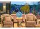 Inviting living room featuring two armchairs, contemporary decor, and tranquil desert views at 7846 E Wilderness Trl, Gold Canyon, AZ 85118