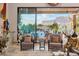 Charming living room featuring beautiful views of desert landscaping through a large picture window and comfortable seating at 7846 E Wilderness Trl, Gold Canyon, AZ 85118