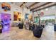 Spacious living room features tall ceilings, beam accents, travertine floors, designer decor, and open floorplan at 7846 E Wilderness Trl, Gold Canyon, AZ 85118