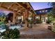 Relaxing outdoor patio with ample seating, desert plants, and decorative lighting features at 7846 E Wilderness Trl, Gold Canyon, AZ 85118