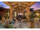 Cozy outdoor living space with covered patio, decorative lighting, and desert landscaping at 7846 E Wilderness Trl, Gold Canyon, AZ 85118