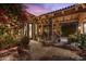 Inviting outdoor patio with covered seating, mature landscaping, and serene setting at 7846 E Wilderness Trl, Gold Canyon, AZ 85118