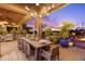 Charming outdoor dining area under covered patio with desert sunset views at 7846 E Wilderness Trl, Gold Canyon, AZ 85118