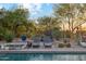 Relaxing poolside view with lounge chairs, desert landscaping, and a tranquil spa at 7846 E Wilderness Trl, Gold Canyon, AZ 85118
