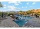 Stunning backyard oasis featuring a sparkling pool, cascading waterfalls, and desert mountain views at 7846 E Wilderness Trl, Gold Canyon, AZ 85118