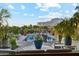 Resort-style pool and spa area with a tranquil water feature, mature landscaping, and desert mountain views at 7846 E Wilderness Trl, Gold Canyon, AZ 85118