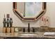 Elegant powder room with a decorative mirror, granite countertop, and refined decor at 7846 E Wilderness Trl, Gold Canyon, AZ 85118