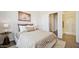 Serene bedroom with minimalist decor, plush bedding, and an ensuite bathroom for added convenience at 8030 W Griswold Rd, Peoria, AZ 85345