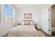 Bright bedroom features a large window, neutral tones, and stylish furnishings at 8030 W Griswold Rd, Peoria, AZ 85345