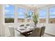 Sunlit dining area with large windows, chandelier, and view of the backyard at 8030 W Griswold Rd, Peoria, AZ 85345