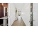 Spacious hallway with wooden floors and decorative wall panels, leading to the staircase and other rooms at 8030 W Griswold Rd, Peoria, AZ 85345