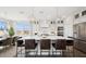 A spacious kitchen with a large center island with seating, stainless steel appliances, and elegant pendant lighting at 8030 W Griswold Rd, Peoria, AZ 85345