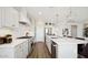 Modern kitchen with quartz countertops, stainless steel appliances, and a stylish vent hood at 8030 W Griswold Rd, Peoria, AZ 85345