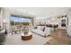 Bright living room with stylish furnishings, sliding glass doors, and seamless flow into the kitchen and outdoor spaces at 8030 W Griswold Rd, Peoria, AZ 85345