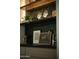 Close-up of bar area with glasses, artwork, and open shelving at 8910 E Topeka Dr, Scottsdale, AZ 85255