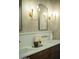 Elegant bathroom with dual sinks, stylish lighting, and modern fixtures at 8910 E Topeka Dr, Scottsdale, AZ 85255