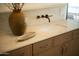 Bathroom vanity with neutral colors and bronze hardware at 8910 E Topeka Dr, Scottsdale, AZ 85255