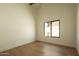 Bright bedroom featuring wood floors and a window at 8910 E Topeka Dr, Scottsdale, AZ 85255