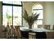Bright dining room with view to outdoors and featuring a modern chandelier and comfortable seating at 8910 E Topeka Dr, Scottsdale, AZ 85255