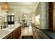 Gourmet kitchen boasting a stone accent wall, large island, stainless appliances, and seamless flow to dining area at 8910 E Topeka Dr, Scottsdale, AZ 85255