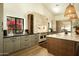 Spacious open concept kitchen with stone accent wall, custom cabinets, and large island for entertaining at 8910 E Topeka Dr, Scottsdale, AZ 85255