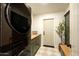 Laundry room with stackable washer/dryer and ample storage and counter space at 8910 E Topeka Dr, Scottsdale, AZ 85255