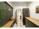 Spacious laundry room with storage, seating bench and modern washer/dryer at 8910 E Topeka Dr, Scottsdale, AZ 85255