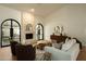 Comfortable living room showcasing fireplace, arched doors, hardwood floors, and stylish decor at 8910 E Topeka Dr, Scottsdale, AZ 85255