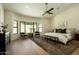 Spacious main bedroom with a ceiling fan, modern decor, and large windows at 8910 E Topeka Dr, Scottsdale, AZ 85255