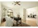 Bright home office boasts natural light, a neutral color palette, and seamless integration with dining room space at 8910 E Topeka Dr, Scottsdale, AZ 85255