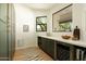 Stylish butler's pantry features a wine cooler, cabinets, shelving, and a view to the outdoors at 8910 E Topeka Dr, Scottsdale, AZ 85255