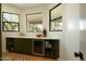 Chic butler's pantry with beverage cooler, sleek countertops, cabinets and shelving plus natural light at 8910 E Topeka Dr, Scottsdale, AZ 85255