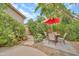 Landscaped backyard patio featuring a charming dining set, gravel and flagstone accents, creating a peaceful outdoor space at 8968 W Adam Ave, Peoria, AZ 85382