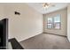 Bedroom with two bright windows, a ceiling fan, and carpet floors at 8968 W Adam Ave, Peoria, AZ 85382