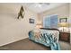 Bedroom featuring a ceiling fan, a framed nautical picture, and bedside lamps at 8968 W Adam Ave, Peoria, AZ 85382