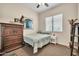 Bedroom with a ceiling fan, a framed jersey, and a dresser at 8968 W Adam Ave, Peoria, AZ 85382