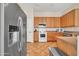 Traditional kitchen with stainless steel appliances, wooden cabinetry and tiled floors at 8968 W Adam Ave, Peoria, AZ 85382