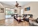 Cozy living room features sliding glass doors to the backyard and comfortable seating at 8968 W Adam Ave, Peoria, AZ 85382
